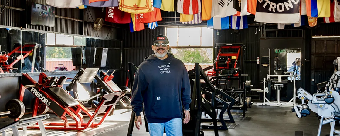 Daniel H stands in his gym, Lift ATX.