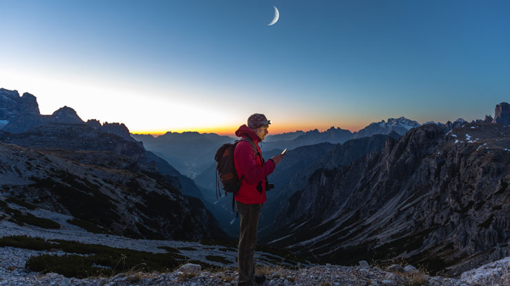 A hiker enjoys the moonrise.
