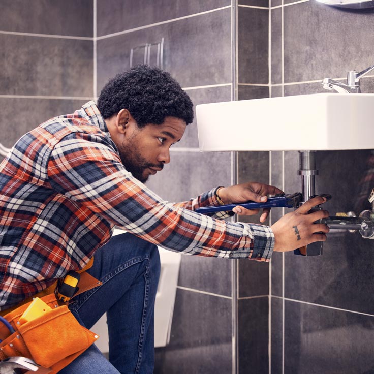 Woman turning sign in shop window to "open"